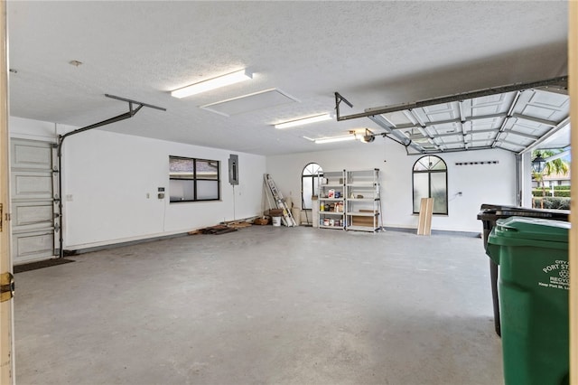 garage featuring a garage door opener and electric panel