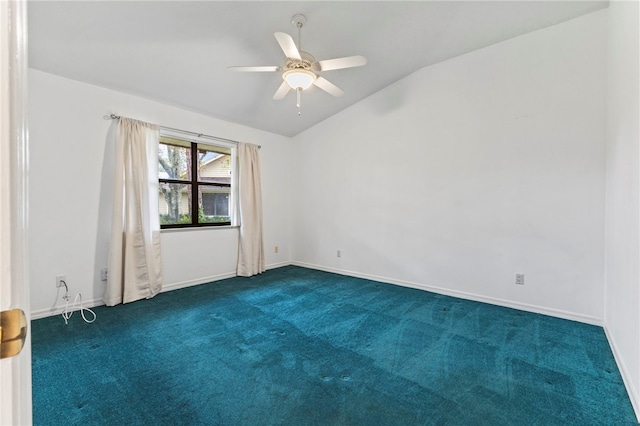 spare room featuring vaulted ceiling, ceiling fan, and dark carpet