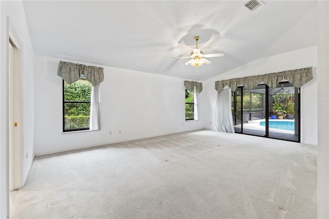 carpeted spare room with lofted ceiling and ceiling fan