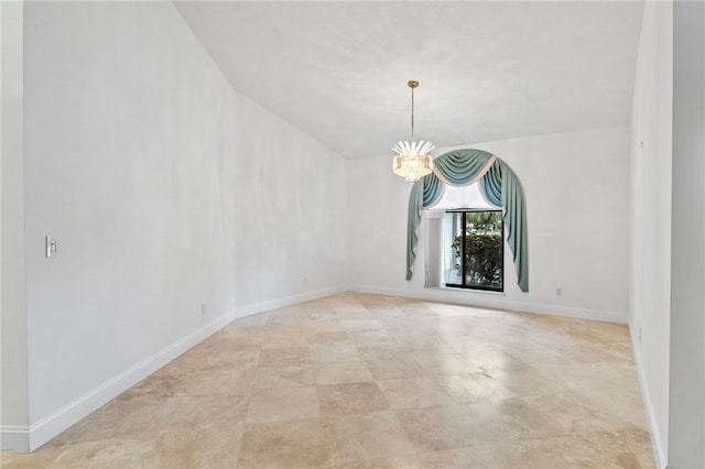 spare room with an inviting chandelier