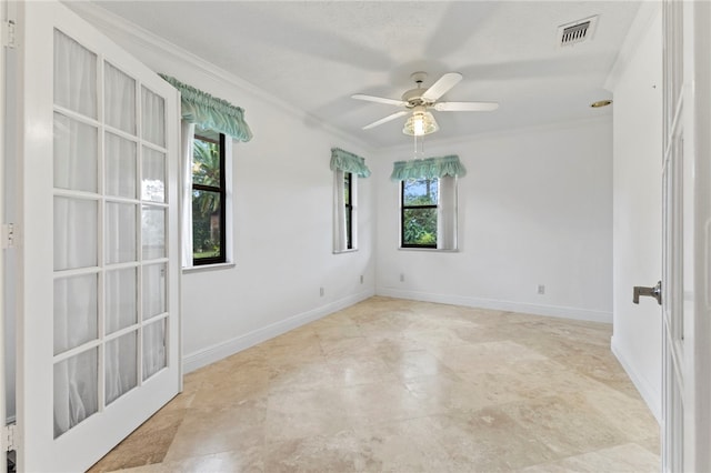 empty room featuring crown molding and ceiling fan