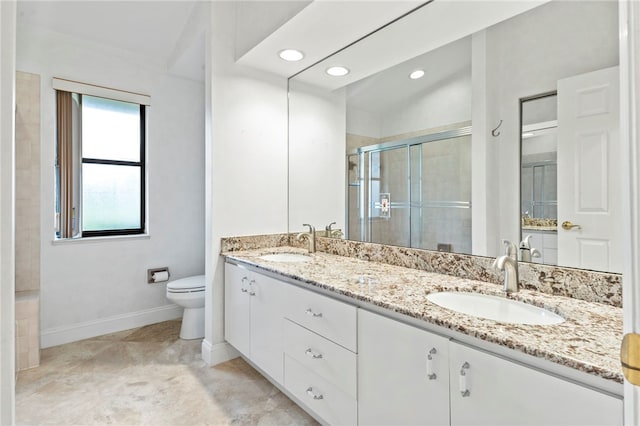 bathroom with vanity, an enclosed shower, and toilet