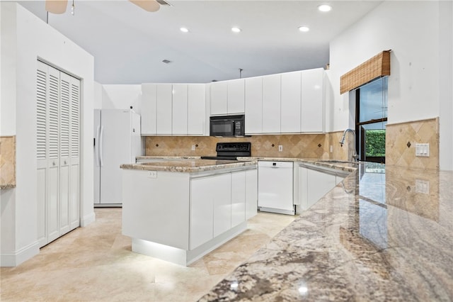 kitchen featuring a kitchen island, sink, white cabinets, light stone counters, and black appliances