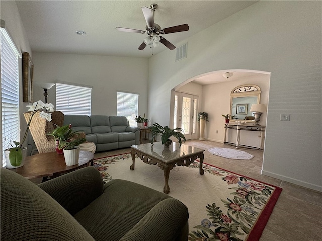 living room featuring high vaulted ceiling, light tile patterned floors, and ceiling fan