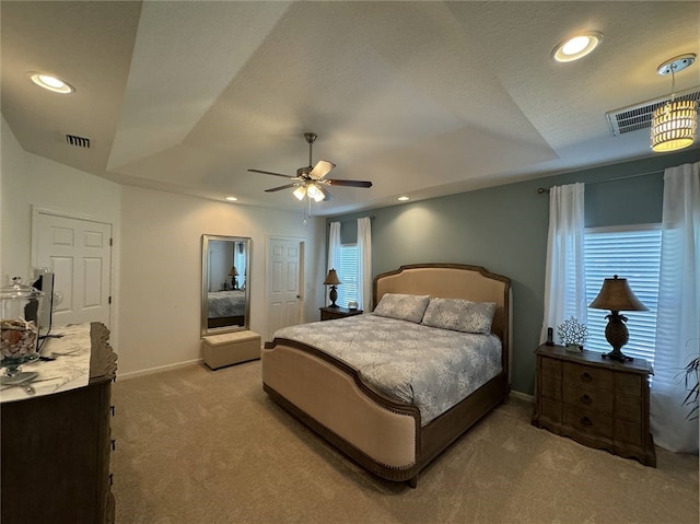 bedroom featuring ceiling fan, a textured ceiling, and light colored carpet