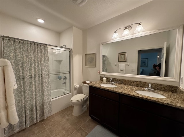 full bathroom featuring toilet, tile patterned floors, a textured ceiling, vanity, and shower / tub combo