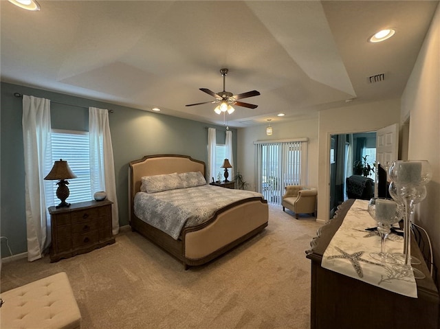 bedroom with multiple windows, light carpet, and ceiling fan