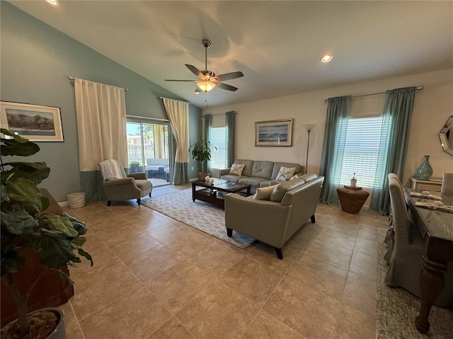 tiled living room featuring ceiling fan and vaulted ceiling