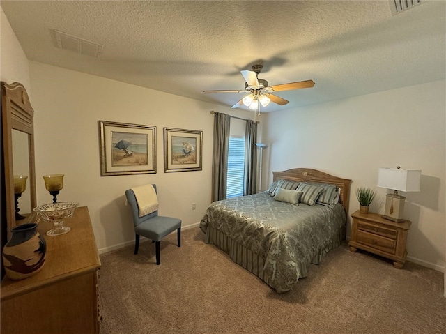 bedroom featuring a textured ceiling, carpet floors, and ceiling fan