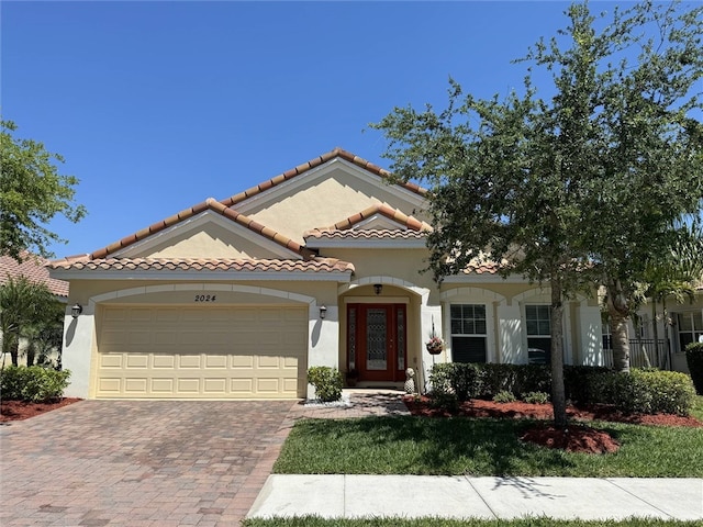 mediterranean / spanish-style home with a garage