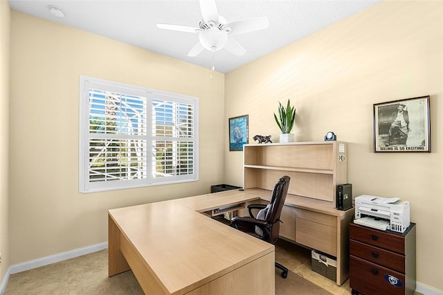 office with light tile patterned floors, a ceiling fan, and baseboards