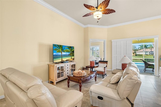 living room with light tile patterned floors, crown molding, a ceiling fan, and a wealth of natural light