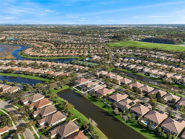 birds eye view of property with a water view and a residential view