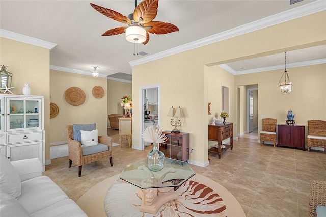 living room featuring visible vents, baseboards, crown molding, and ceiling fan with notable chandelier