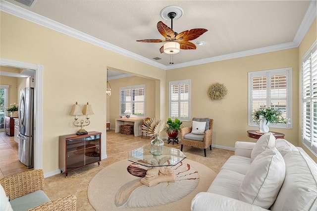 living area with visible vents, a healthy amount of sunlight, a ceiling fan, and crown molding