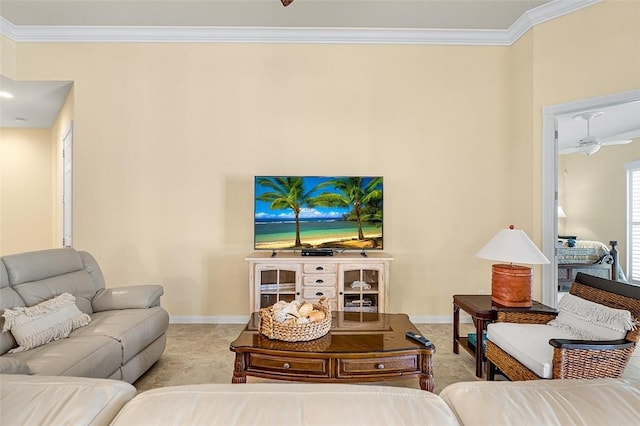 carpeted living room with a ceiling fan, baseboards, and crown molding