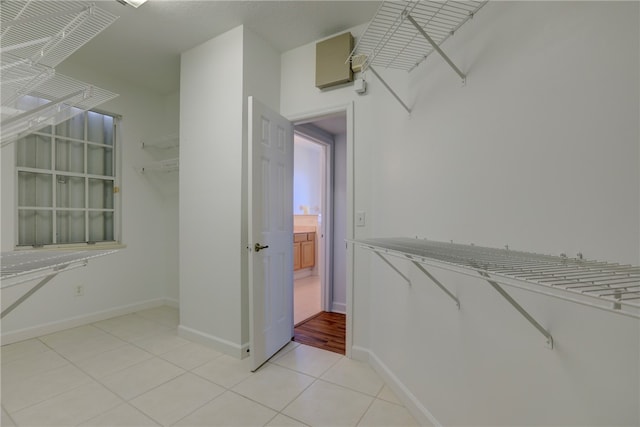 walk in closet with light tile patterned floors