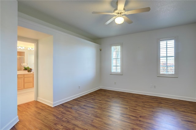 unfurnished room featuring ceiling fan and dark hardwood / wood-style floors