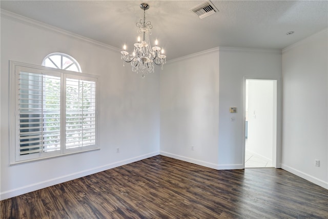 unfurnished room featuring a notable chandelier, dark hardwood / wood-style flooring, ornamental molding, and a textured ceiling