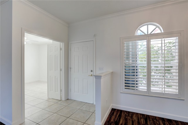 entrance foyer featuring light tile patterned floors, ceiling fan, and crown molding