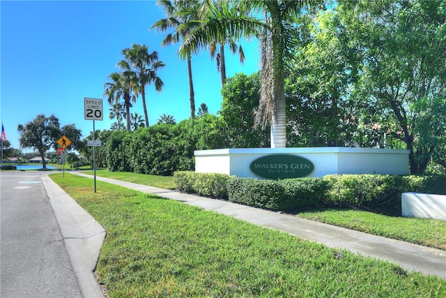 community sign featuring a lawn