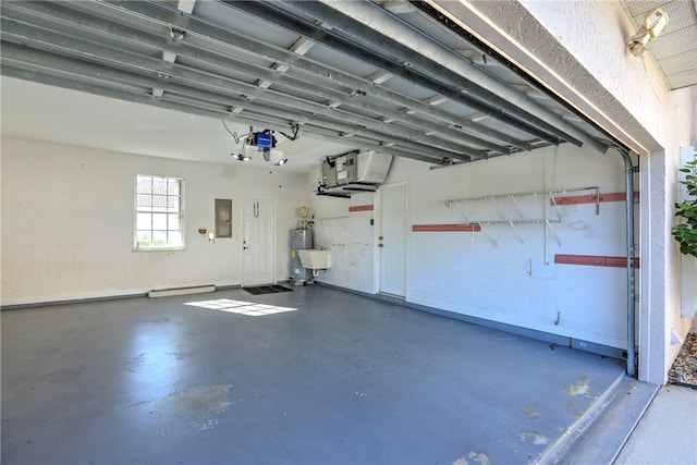 garage featuring electric panel and water heater