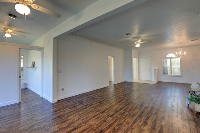 unfurnished living room with ceiling fan with notable chandelier, dark wood-type flooring, a textured ceiling, and ornamental molding