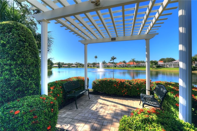 view of patio / terrace with a pergola and a water view