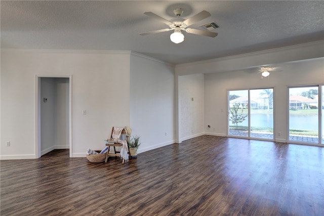 spare room with a textured ceiling, ceiling fan, crown molding, a water view, and dark hardwood / wood-style floors