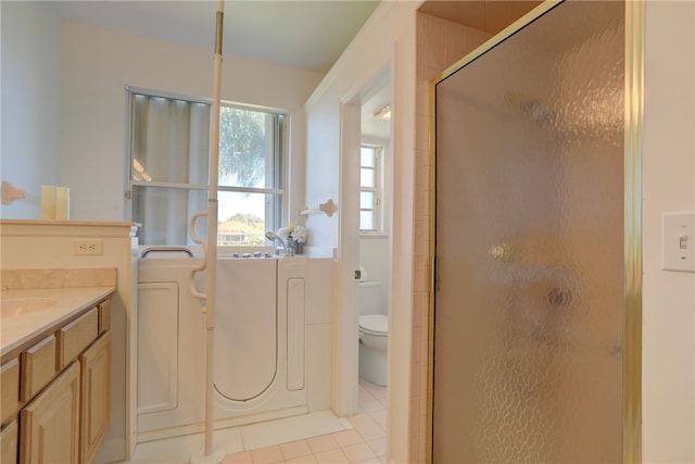 bathroom featuring walk in shower, tile patterned flooring, vanity, and toilet