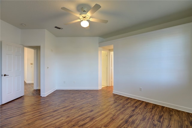 spare room with dark hardwood / wood-style floors and ceiling fan