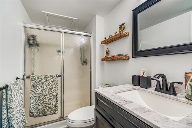 bathroom featuring vanity, toilet, and an enclosed shower