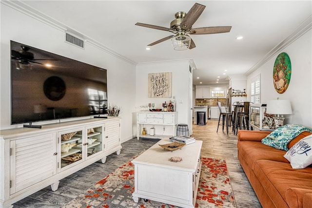 living room featuring crown molding and ceiling fan