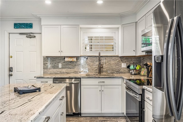 kitchen featuring stainless steel appliances, white cabinetry, crown molding, and sink