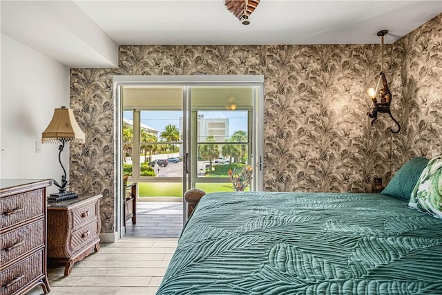 1441 Ocean Dr Unit 207, Vero Beach, FL 32963 - bedroom featuring wallpapered walls, access to outside, and light wood-style floors
