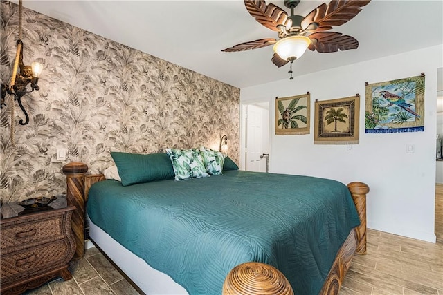 1441 Ocean Dr Unit 207, Vero Beach, FL 32963 - bedroom with wallpapered walls, ceiling fan, and wood finished floors