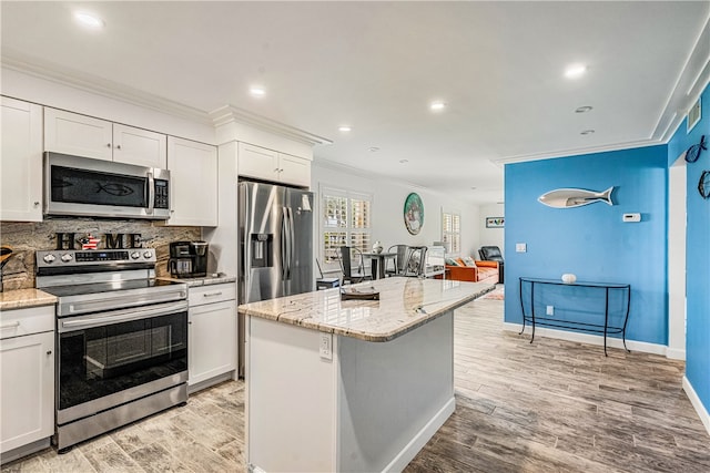 kitchen with white cabinetry, a kitchen island, and stainless steel appliances