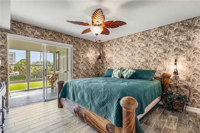 bedroom featuring hardwood / wood-style flooring, ceiling fan, and access to outside