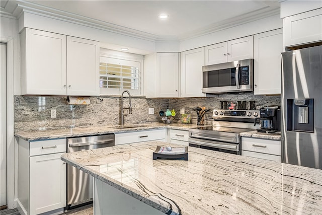 kitchen featuring sink, stainless steel appliances, light stone counters, white cabinets, and ornamental molding