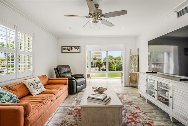 living room featuring ceiling fan, light hardwood / wood-style floors, and ornamental molding