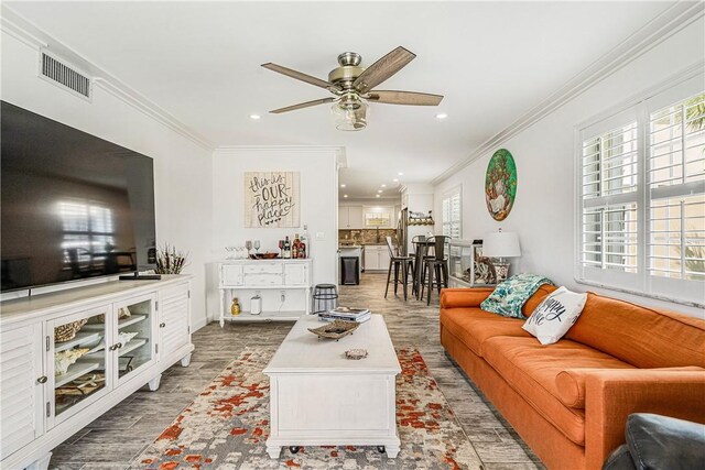 1441 Ocean Dr Unit 207, Vero Beach, FL 32963 - living room with wood finished floors, crown molding, a ceiling fan, recessed lighting, and baseboards