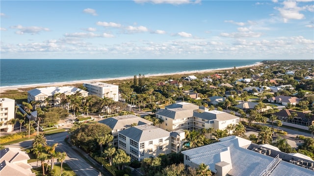 drone / aerial view with a water view and a beach view