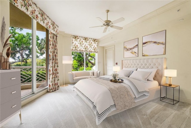 bedroom with a ceiling fan, crown molding, and carpet