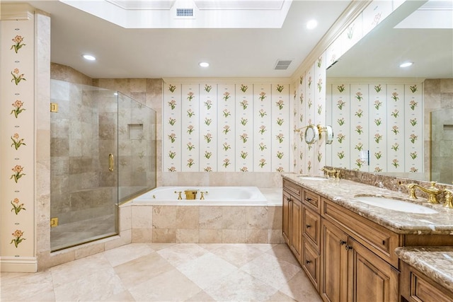 bathroom featuring a skylight, a bath, visible vents, and a sink