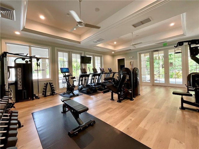 exercise room with visible vents, french doors, and a raised ceiling