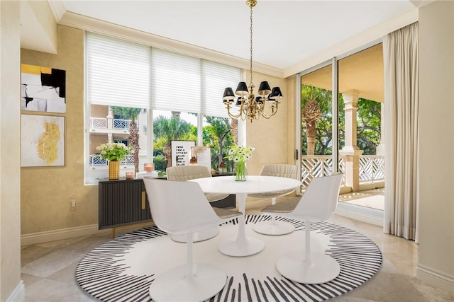 dining room with a notable chandelier, floor to ceiling windows, baseboards, and ornamental molding