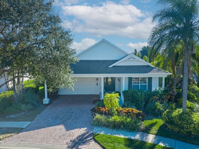 view of front of house with decorative driveway and a garage