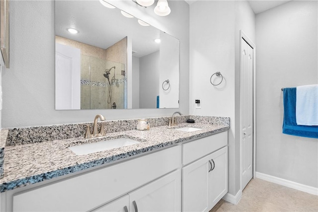 bathroom with vanity, tile patterned floors, and a shower with door