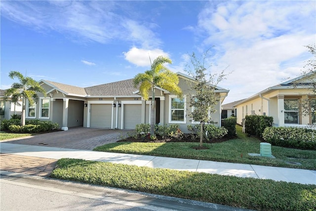 view of front facade with a garage and a front lawn