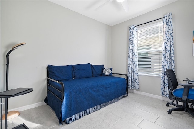 tiled bedroom featuring ceiling fan